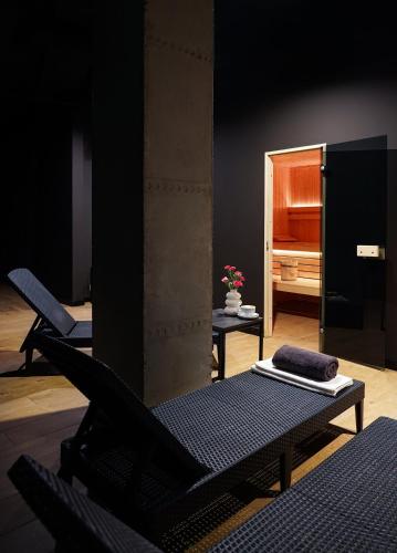 a black room with two beds and a mirror at Hotel Convictus Cracovia for business & travellers in Kraków
