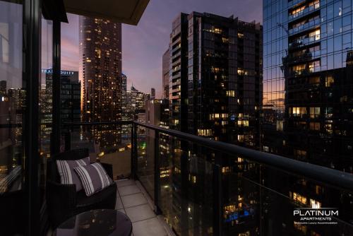a balcony with a view of a city at night at Platinum Luxury Stays The Grande Large 4 BRM 3 Bath Apt in Melbourne