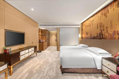 Postel nebo postele na pokoji v ubytování Shijiazhuang Ximeijin Continental Hotel