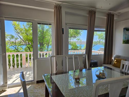 a living room with a dining table and a balcony at Apartment Zdenka in Dinjiška
