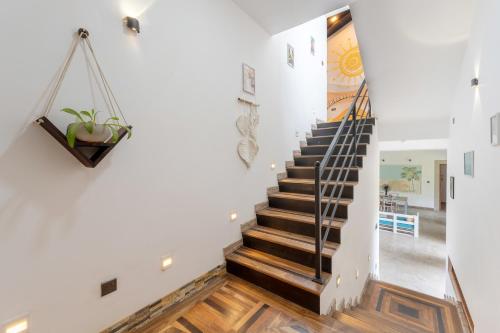 a staircase in a home with white walls and wooden floors at Artisan By Sebu in Galle
