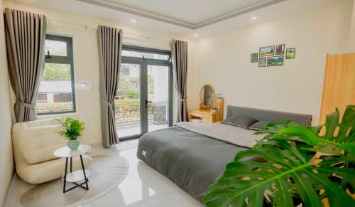 a bedroom with a bed and a couch and a window at Amy Hotel & Apartment in Da Thanh