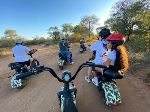 a group of people riding motorcycles on a dirt road at Lindiwe Safari Lodge in Hoedspruit