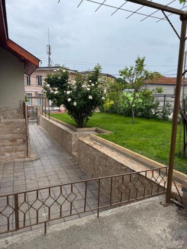 a walkway with a fence next to a building at Стаи за гости - Дара Девня 1 in Devnya