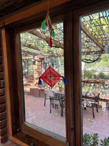 a window view of a patio with a kite at Quinta Maria en la Ruta del Vino in Valle de Guadalupe