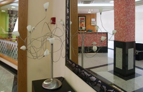 a room with a mirror and a lamp on a table at Pontus Veteris in Sanxenxo