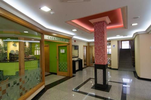 a lobby with a column in the middle of a building at Pontus Veteris in Sanxenxo