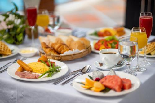 un tavolo sormontato da piatti di cibo e bevande di Ree Mohasambath Hotel & Resort a Phumĭ Thnál