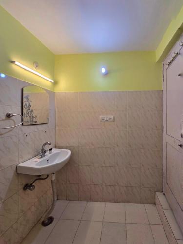 a bathroom with a sink and a mirror at Hotel City Gold - Hotel in Dharamshala in Dharmsala