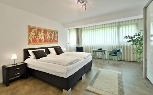 a bedroom with a large bed and a table at Ferienwohnung im "Liebig-Haus" in Poppenhausen