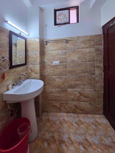 a bathroom with a sink and a glass shower at Hotel City Gold - Hotel in Dharamshala in Dharmsala