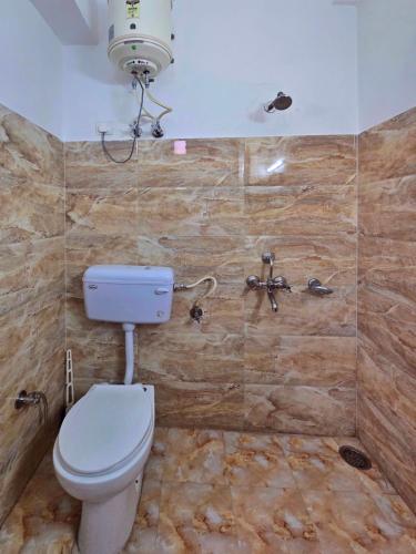 a bathroom with a toilet and a shower at Hotel City Gold - Hotel in Dharamshala in Dharmsala
