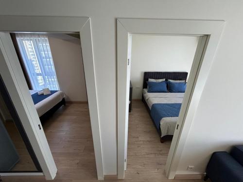 a bedroom with a bed and a mirror at Real Beach Tower in Batumi