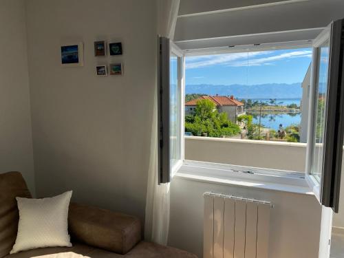 a room with a window with a view of the water at Dalmatia Nin apartment in Nin