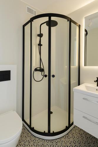 a glass shower in a bathroom with a toilet at SeaSide in Gdańsk