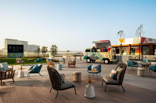 a group of chairs and chairs on a patio at Rove Al Marjan Island in Ras al Khaimah