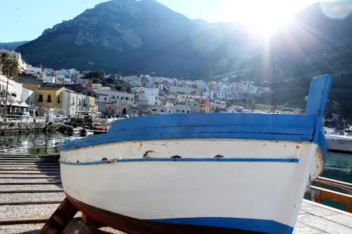 a boat sitting on a dock next to the water at La Blanca Resort & Spa in Castellammare del Golfo