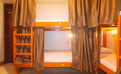 a room with two bunk beds in a room at Stay Malate Hostel by RedDoorz in Manila