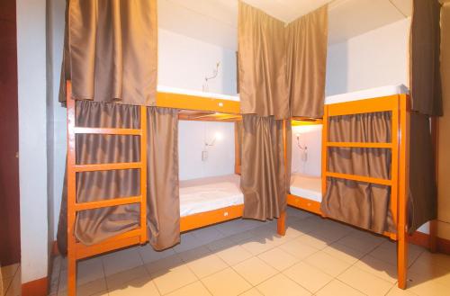a room with two bunk beds in a room at Stay Malate Hostel by RedDoorz in Manila