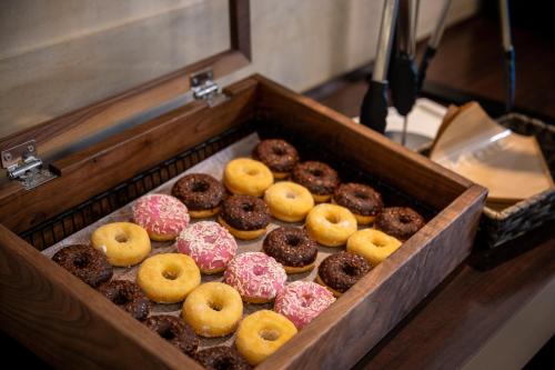 a wooden box filled with different types of donuts at the b hakata in Fukuoka