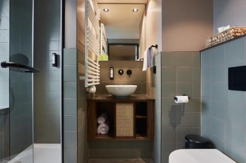 a bathroom with a sink and a shower at Cocoon Salzburg in Salzburg