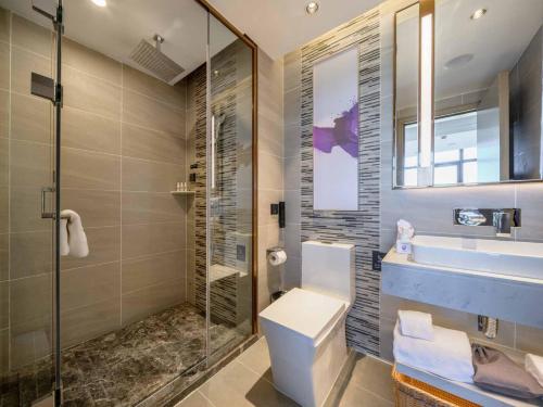 a bathroom with a toilet and a sink and a shower at Lavande Hotel Dongguan Songshan Lake in Dongguan