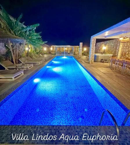 a swimming pool at night in a villaolis azulejo at Lindos Villa Aqua Euphoria ex Natura in Líndos