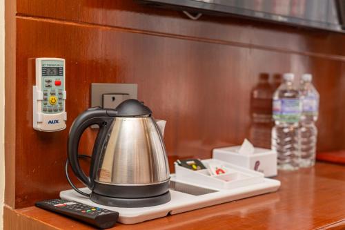 a tea kettle on a counter next to a remote control at Amarawati Boutique Hotel in Kathmandu