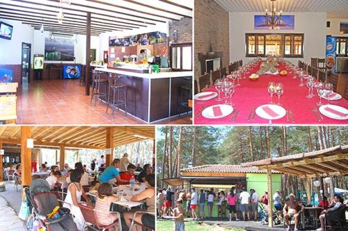 a group of people sitting at tables in a restaurant at Camping Urbion in Abejar