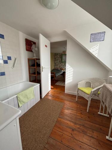 a room with a staircase with a table and chairs at Chambres Dhôtes Numéro 1 in Châteaulin
