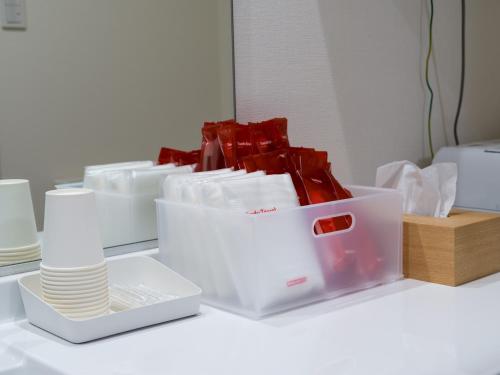 a group of white containers sitting on a table at Rakuten STAY HOUSE x WILL STYLE Sasebo in Sasebo