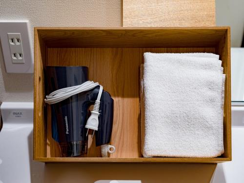 a wooden box with a utensils in it at Rakuten STAY HOUSE x WILL STYLE Sasebo in Sasebo