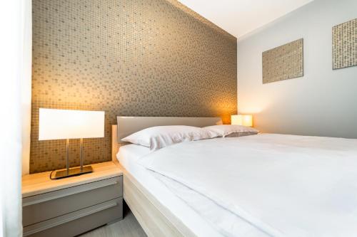a bedroom with a bed and a lamp on a night stand at AH Fatranska VUSCH in Košice