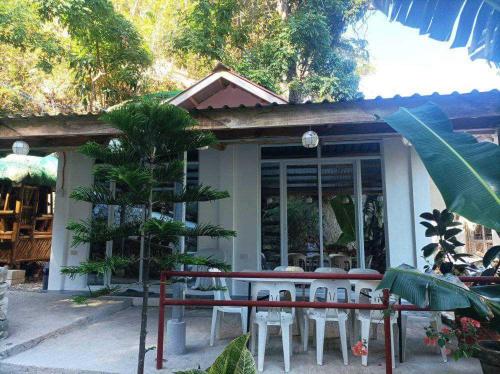 a table and chairs in front of a building at E - House VILLA Kristina in Lobo