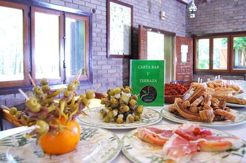 a table with plates of food on top at Camping Urbion in Abejar