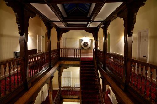 an empty hallway with a staircase in a building at The Knighton Hotel in Knighton