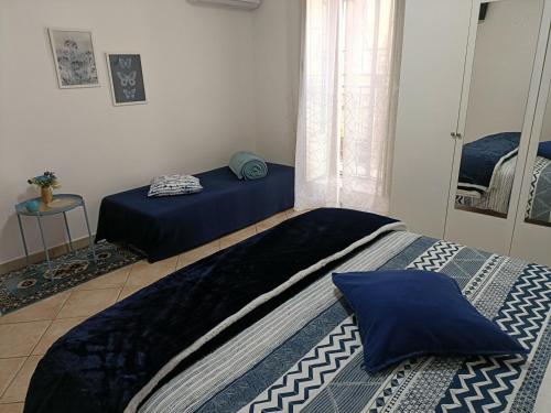 a bedroom with two beds and a window at La Casa di Bianca in Caltagirone