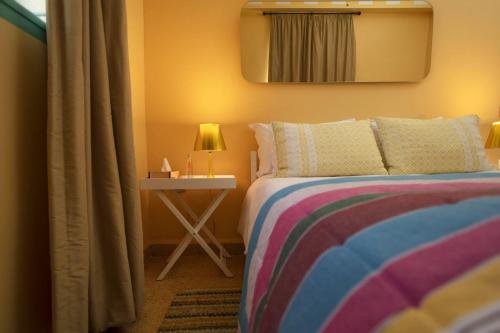 a bedroom with a bed and a side table at Al Fundok Boutique Hotel in Maasser El Chouf