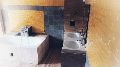 a bathroom with a sink and a tub and a sink at Villa Organica in Vroutek