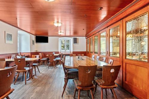 a dining room with wooden tables and chairs at Gasthaus Hirschen Holl in Elbenschwand