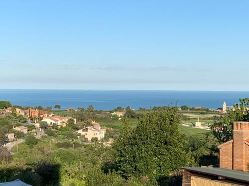 a view of a town with the ocean in the background at Alle Pendici del Conero in Sirolo