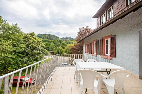 a patio with a white table and chairs on a balcony at Gasthaus Hirschen Holl in Elbenschwand
