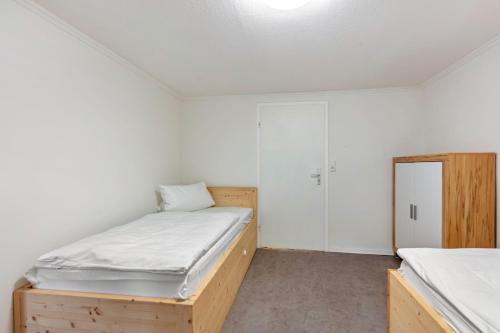 a small bedroom with two beds and a closet at Gasthaus Hirschen Holl in Elbenschwand