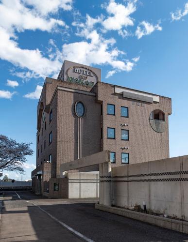 a building with a clock on the side of it at ホテルネオワカバ in Tsuchiura