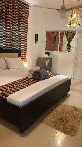 a bedroom with a large bed in a room at African Treasure Beach Resort in Kokrobite