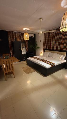 a bedroom with a large bed in a room at African Treasure Kokrobite in Kokrobite