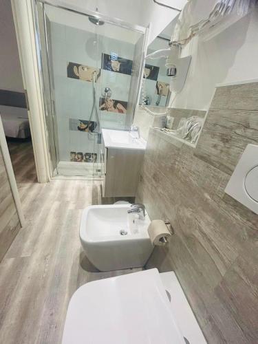 a bathroom with a white toilet and a sink at Hotel Giardinetto Al Sant'Orsola in Bologna