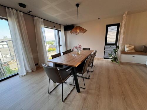 a dining room with a wooden table and chairs at Villa Parkveien in Lillesand