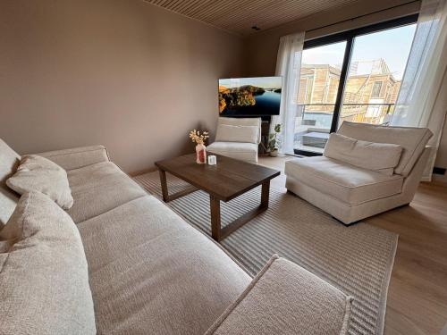 a living room with a couch and a coffee table at Villa Parkveien in Lillesand