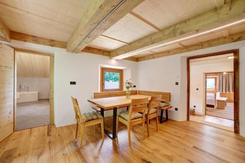 a dining room with a wooden table and chairs at Schlossbauer große Ferienwohnung in San Leonardo in Passiria